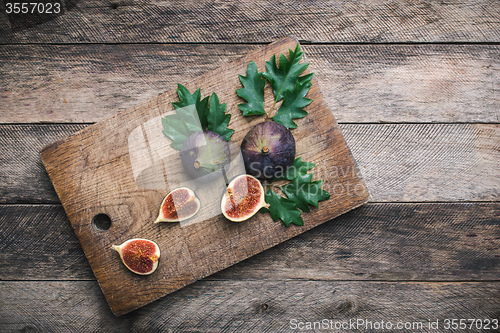 Image of Cut Figs on chopping board and wood table