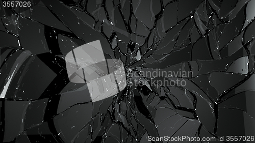 Image of Pieces of broken and cracked glass on black