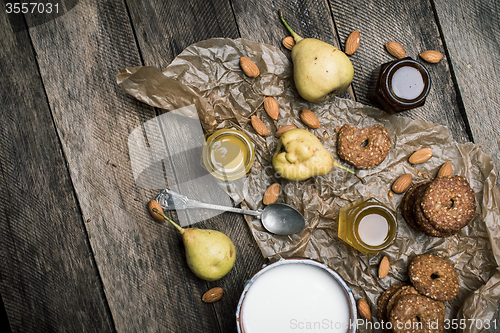 Image of Pears nuts Cookies and joghurt on rustic wood