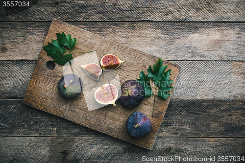 Image of Ripe Figs on chopping board and wood