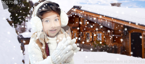 Image of happy little girl wearing earmuffs