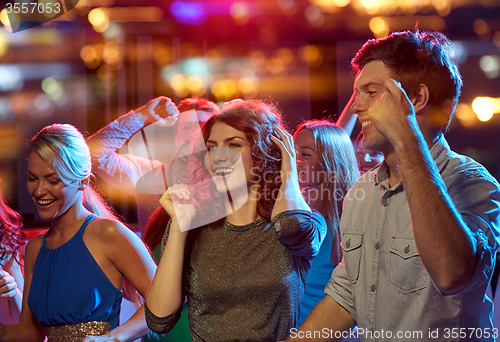 Image of group of happy friends dancing in night club