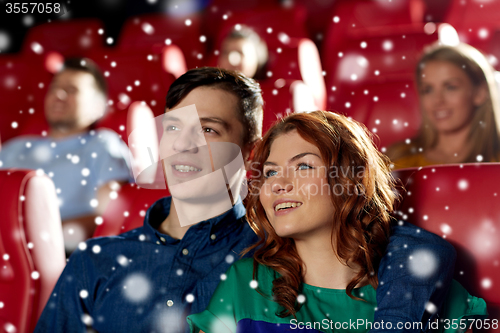 Image of happy couple watching movie in theater