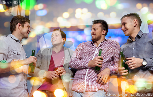 Image of group of male friends with beer in nightclub
