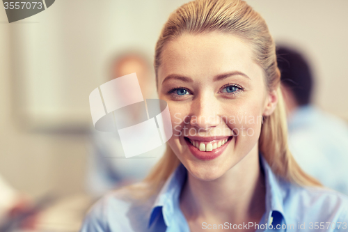 Image of group of smiling businesspeople meeting in office