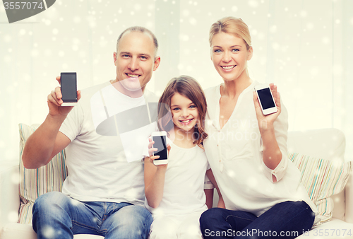 Image of happy family showing smartphones blank screens