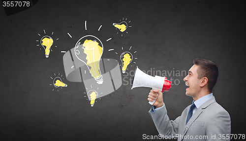 Image of happy businessman in suit speaking to megaphone