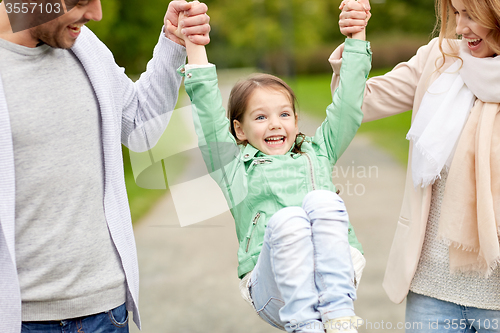 Image of happy family walking in summer park and having fun