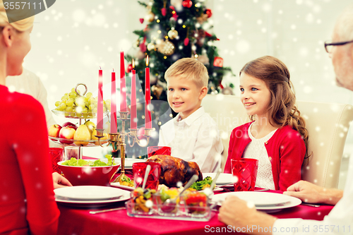 Image of smiling family having holiday dinner at home