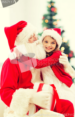 Image of smiling little girl with santa claus