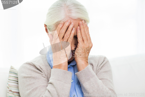 Image of senior woman suffering from headache or grief