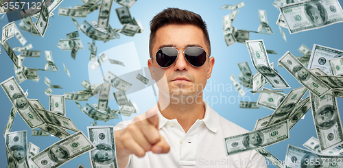 Image of man pointing on you with falling dollar money