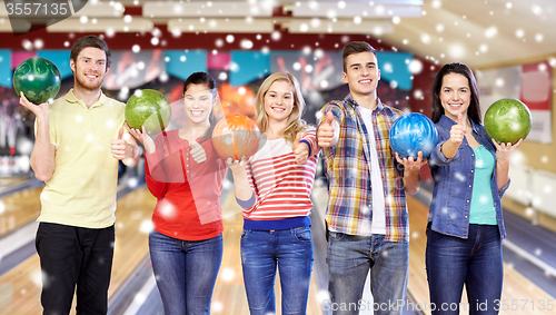 Image of happy friends in bowling club at winter season