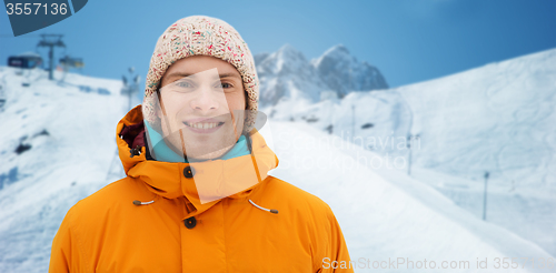 Image of happy young man in winter clothes outdoors