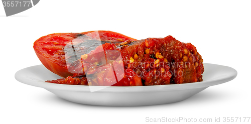 Image of Rotting tomato on white plate
