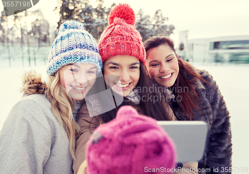 Image of happy teenage girls taking selfie with smartphone