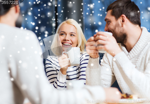 Image of happy friends meeting and drinking tea or coffee