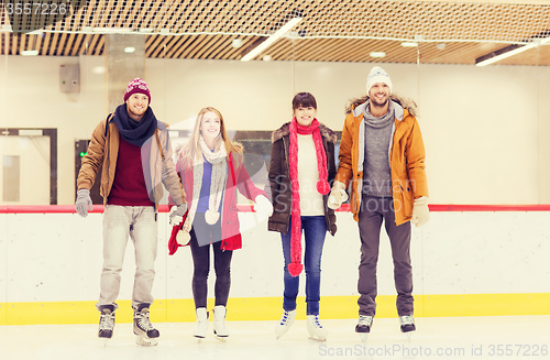 Image of happy friends on skating rink