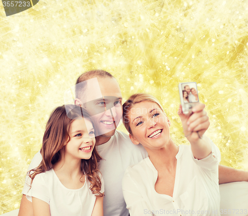 Image of happy family with camera at home
