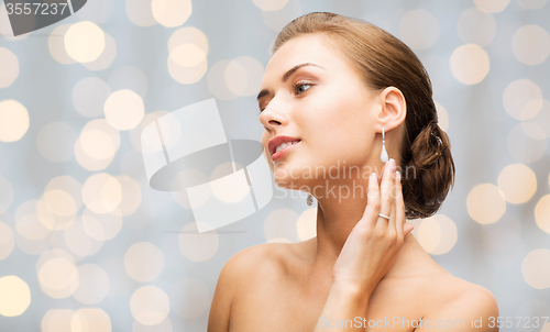 Image of beautiful woman with diamond earrings and bracelet