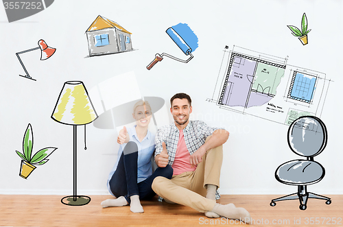 Image of happy couple showing thumbs up at new home