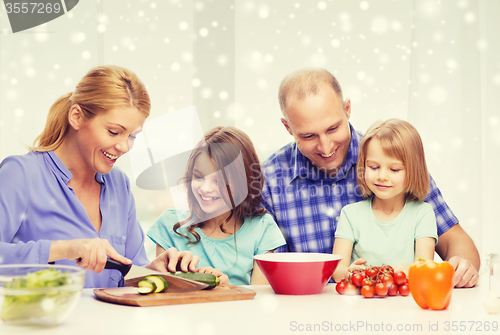 Image of happy family with two kids making dinner at home