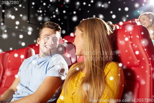 Image of happy couple watching movie in theater