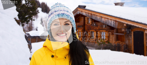 Image of happy young woman in winter clothes outdoors