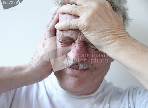 Image of senior man with terrible headache 