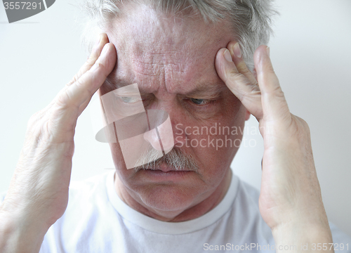 Image of temple headache in older man