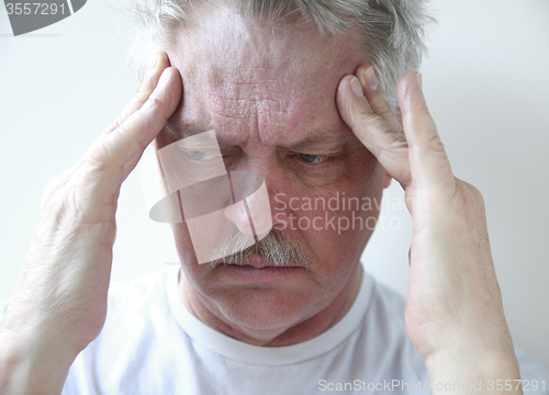 Image of temple headache in older man