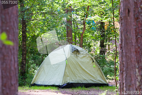 Image of camping outdoor with  tent in woods in summer 