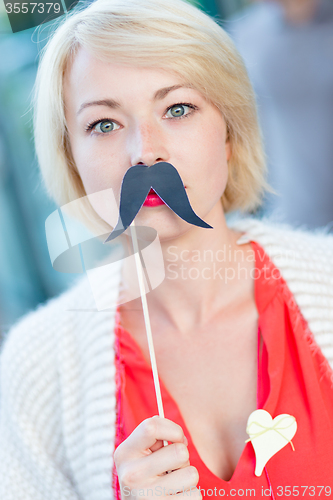 Image of Woman with fake mustache.