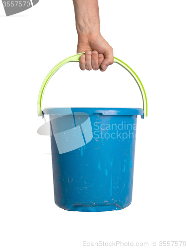 Image of Human hand holding empty plastic pail