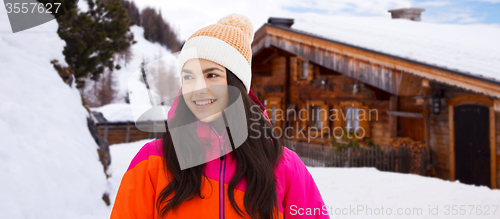 Image of happy young woman in winter clothes outdoors