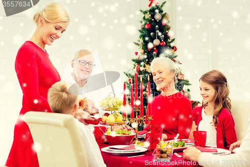 Image of smiling family having holiday dinner at home