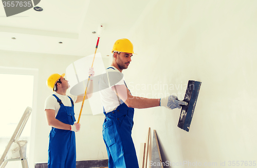 Image of group of builders with tools indoors