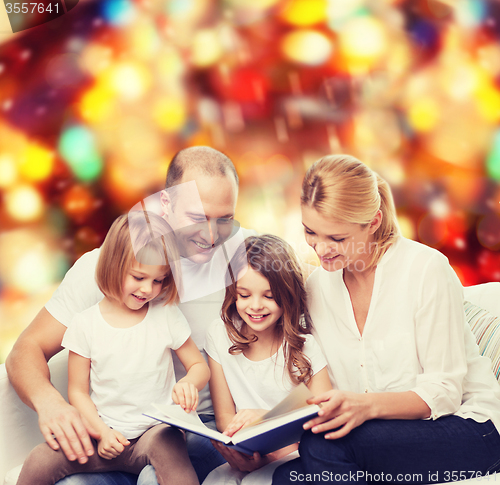 Image of happy family with book at home