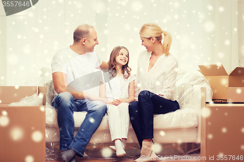 Image of smiling parents and little girl at new home