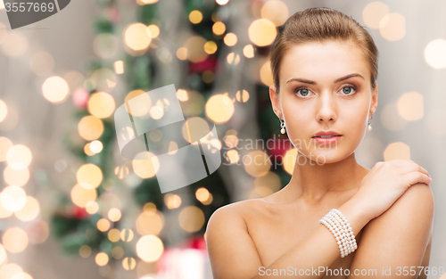 Image of beautiful woman with pearl earrings and bracelet