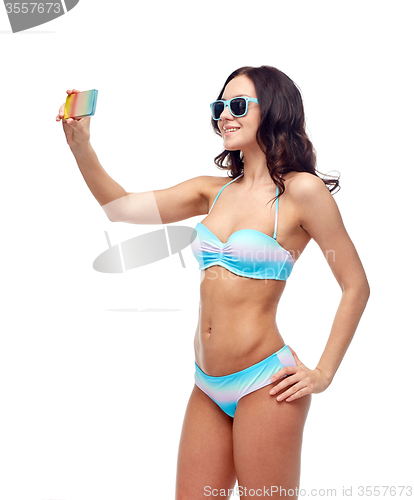 Image of woman in swimsuit taking selfie with smatphone