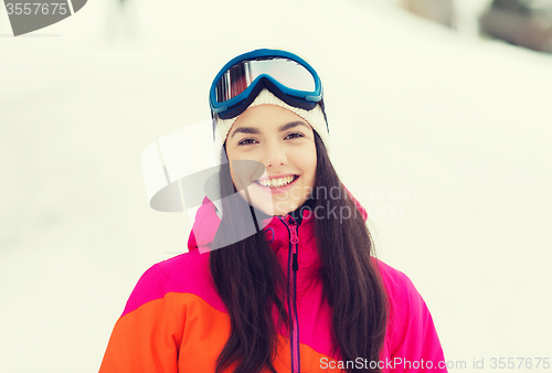 Image of happy young woman in ski goggles outdoors