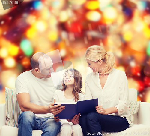 Image of happy family with book at home