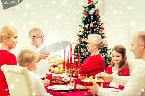 Image of smiling family having holiday dinner at home