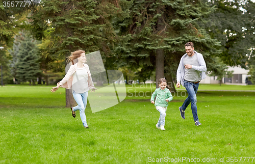 Image of happy family walking in summer park