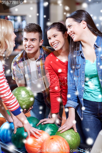 Image of happy friends in bowling club at winter season