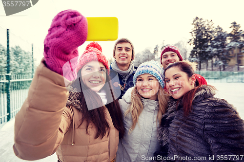 Image of happy friends taking selfie with smartphone