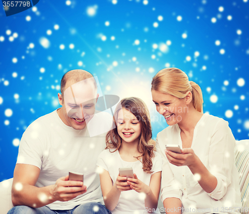 Image of happy family with smartphones