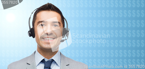 Image of businessman in headset over dollar currency symbol