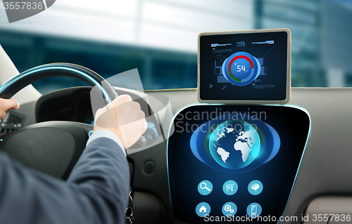 Image of close up of businessman with tablet pc driving car